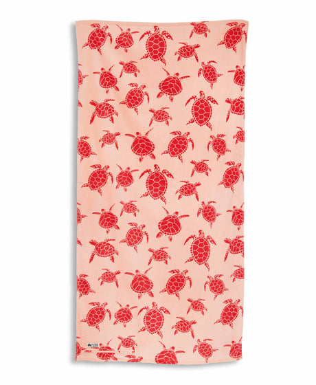 Beach towel with pink turtle pattern on a white background