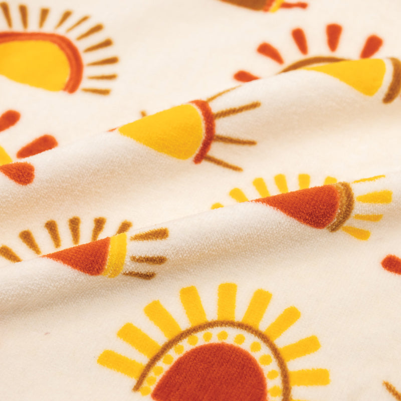 Up close of towel with pattern of suns on it