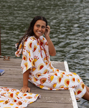 Woman on a dock in sun-print towel poncho with matching towel
