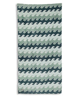 Towel with wave pattern in blue and green on a white background