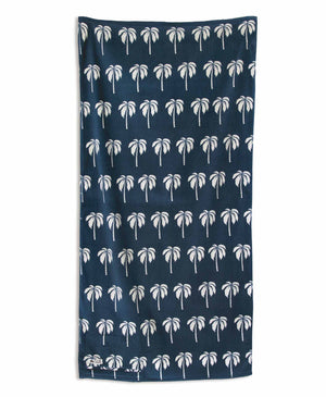 Navy blue towel with white palm tree pattern on a white background