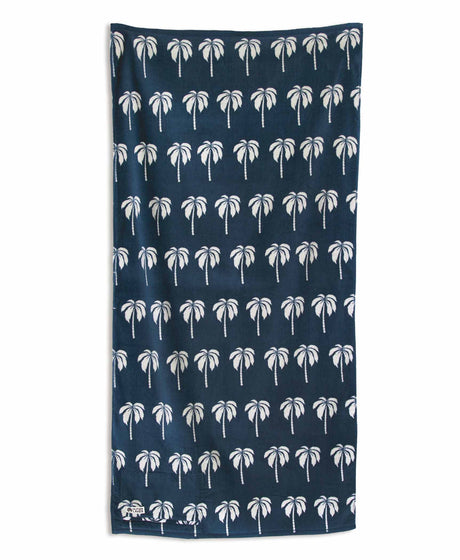 Navy blue towel with white palm tree pattern on a white background