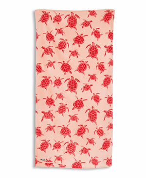 Beach towel with pink turtle pattern on a white background