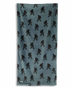 Blue towel with black Sasquatch pattern on a white background